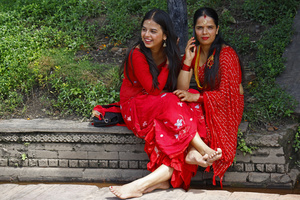 Women take part during the Teej festival at Pashupatinath Temple. Married and unmarried Hindu women observe fasting during the festival. Married women traditionally abstain from food and water while praying for the longevity, peace, and prosperity of their husbands and families, while unmarried women fast in the hope of being blessed with good husbands.