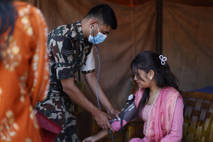 A woman gets her blood pressure checked during the Teej festival at Pashupatinath Temple. Married and unmarried Hindu women observe fasting during the festival. Married women traditionally abstain from food and water while praying for the longevity, peace, and prosperity of their husbands and families, while unmarried women fast in the hope of being blessed with good husbands.