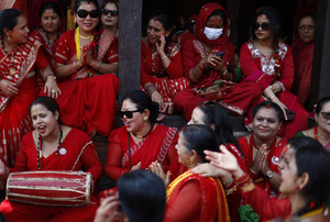 Women sing during the Teej festival at Pashupatinath Temple. Married and unmarried Hindu women observe fasting during the festival. Married women traditionally abstain from food and water while praying for the longevity, peace, and prosperity of their husbands and families, while unmarried women fast in the hope of being blessed with good husbands.