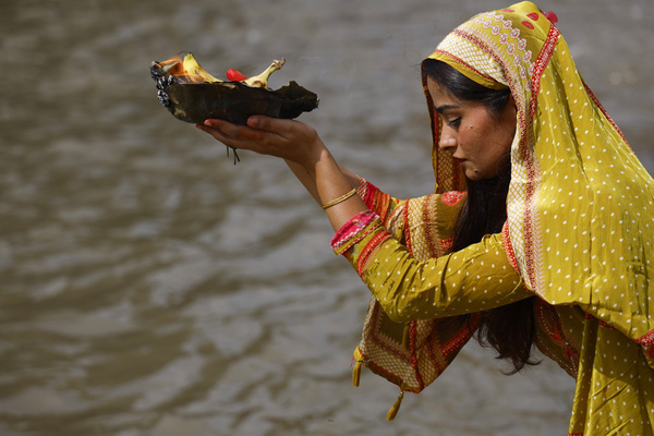 A Nepali Hindu woman prays during the Rishi Panchami festival on the banks of the Bagmati River. Rishi Panchami marks the final day of the three-day Teej festival, when women worship the Saptarishi, or Seven Sages, and traditionally cleanse their bodies with 365 stems of Apamarga, a medicinal plant, along with cow dung, sacred soil, and ash, in the belief that the ritual purifies them and absolves sins believed to have been incurred during menstruation.