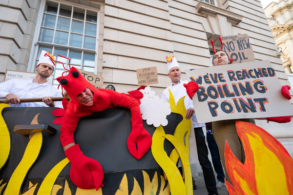 Activists from Fossil Free London stage a protest outside the Department for Energy Security and Net Zero (DESNZ) in Whitehall. The protest feature a giant lobster inside a cooking pot surrounded by demonstrators dressed as ‘Shell chefs’. The lobster represents a planet being pushed towards dangerous levels of warming, while the ‘Shell chefs’ represent the fossil fuel industry continuing to pursue new oil and gas projects. The action comes as the Government faces pressure over new North Sea oil and gas developments, including the Rosebank and Jackdaw fields.