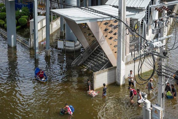 A view of a metro entrance as people walk or use boats through the floodwater to reach it on Lat Phrao Road in Bang Kapi District. On September 26, all 50 districts of Bangkok were declared disaster-affected areas. Three days later, floodwaters still remained in parts of the city. In heavily affected areas such as Bang Kapi District, residents remained in floodwater.