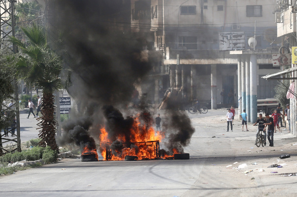 Palestinians set fire to tires in the streets of the Balata refugee camp in protest against the visit of Jewish settlers to "Joseph's Tomb" a religious site that is a point of contention between Israelis and Palestinians as Jewish visitors arrive late at night to pray there during the festival of Sukkot; the site is located in an area under the control of the Palestinian Authority.