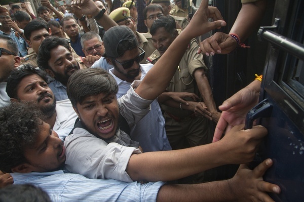 Lucknow police officials detain members of the Students’ Federation of India (SFI) and Left party workers during a protest against Election Commissioner Gyanesh Kumar at Parivartan Crossing.