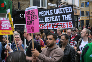 Protesters seen carrying signs as they enter Cable Street during the rally. The 90th anniversary of the Battle of Cable Street is commemorated on Sunday 4 October 2026 in the east end of London. Despite the make-up having changed greatly over the last nine decades, thousands still marched through the streets to oppose Fascism and Zionism. In 1936, over 100,000 Jewish residents, Irish dockers, trade unionists, and local working-class communities stood shoulder to shoulder and repelled Sir Oswald Mosley's British Union of Fascists.