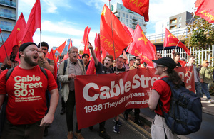 Supporters of the communist party seen chanting slogans while holding red banner and flags during the march along Cable Street . The 90th anniversary of the Battle of Cable Street is commemorated on Sunday 4 October 2026 in the east end of London. Despite the make-up having changed greatly over the last nine decades, thousands still marched through the streets to oppose Fascism and Zionism. In 1936, over 100,000 Jewish residents, Irish dockers, trade unionists, and local working-class communities stood shoulder to shoulder and repelled Sir Oswald Mosley's British Union of Fascists.