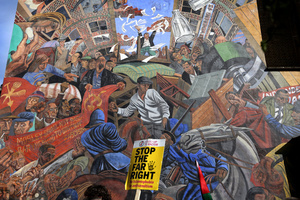 A protester(not seen) passes the Cable Street mural while carrying a sign against the ‘Far Right’ during the rally. The 90th anniversary of the Battle of Cable Street is commemorated on Sunday 4 October 2026 in the east end of London. Despite the make-up having changed greatly over the last nine decades, thousands still marched through the streets to oppose Fascism and Zionism. In 1936, over 100,000 Jewish residents, Irish dockers, trade unionists, and local working-class communities stood shoulder to shoulder and repelled Sir Oswald Mosley's British Union of Fascists.