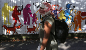 A protester, his head covered by a Palestinian keffiyeh seen passing a mural containing the message ‘Fascists Not Welcome Here’ in Cable Street during the rally. The 90th anniversary of the Battle of Cable Street is commemorated on Sunday 4 October 2026 in the east end of London. Despite the make-up having changed greatly over the last nine decades, thousands still marched through the streets to oppose Fascism and Zionism. In 1936, over 100,000 Jewish residents, Irish dockers, trade unionists, and local working-class communities stood shoulder to shoulder and repelled Sir Oswald Mosley's British Union of Fascists.