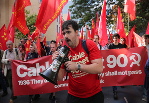 Supporters of the communist party seen chanting slogans while holding red banner and flags during the march along Cable Street . The 90th anniversary of the Battle of Cable Street is commemorated on Sunday 4 October 2026 in the east end of London. Despite the make-up having changed greatly over the last nine decades, thousands still marched through the streets to oppose Fascism and Zionism. In 1936, over 100,000 Jewish residents, Irish dockers, trade unionists, and local working-class communities stood shoulder to shoulder and repelled Sir Oswald Mosley's British Union of Fascists.