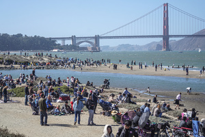 People watch the air show along the waterfront. Crowds gather along the waterfront to watch the San Francisco Fleet Week Air Show as aircraft, including the U.S. Navy Blue Angels, performed in the skies over the city. The annual event is part of San Francisco Fleet Week, which celebrates the U.S. military and honors the men and women serving in the armed forces.