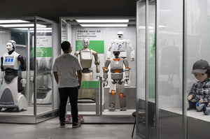 A visitor looks at different robots prototypes on displayed during the 'ROBOTS' exhibition at the Hong Kong Science Museum in Hong Kong on May 8, 2021. The exhibition explores the 500-year story of humanoid robots and the artistic and scientific quest to understand what it means to be human.