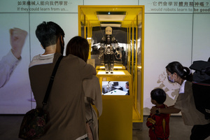 Visitors are seen during the 'ROBOTS' exhibition at the Hong Kong Science Museum in Hong Kong on May 8, 2021. The exhibition explores the 500-year story of humanoid robots and the artistic and scientific quest to understand what it means to be human.