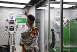 A visitor interacts with British 'RoboThespian' during the 'ROBOTS' exhibition at the Hong Kong Science Museum in Hong Kong on May 8, 2021. The exhibition explores the 500-year story of humanoid robots and the artistic and scientific quest to understand what it means to be human.