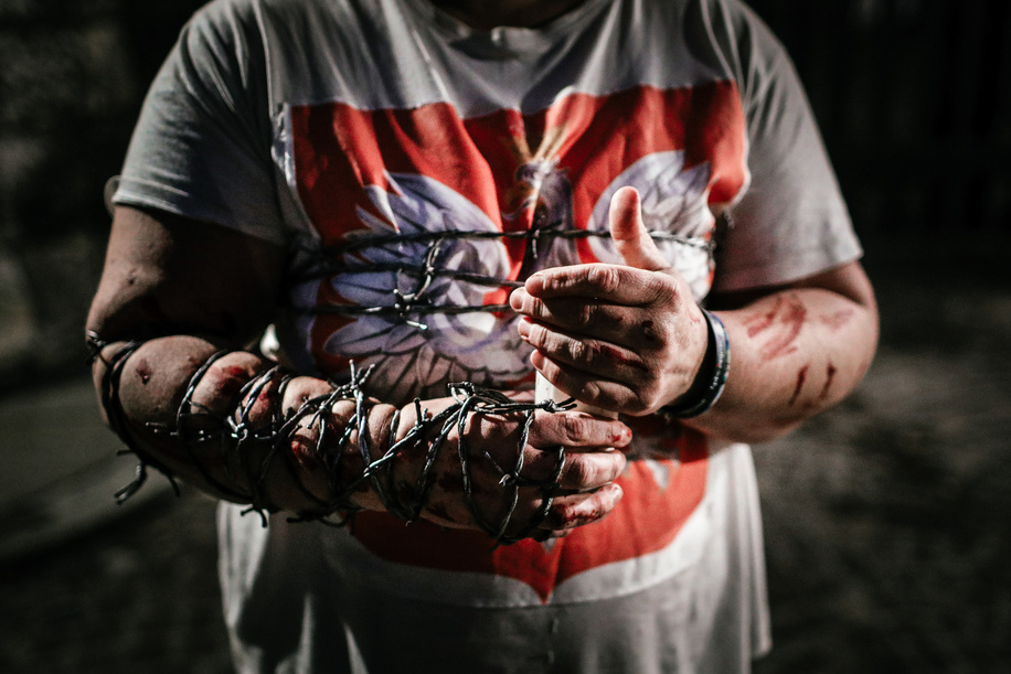 A protester with a bleeding hand wrapped with barbed wire, holding a candle, during a demonstration against the visits.In 2010 Polish President Lech Kaczynski died in an airplane crash along with over one hundred delegates, mostly important state officials. Since then his twin brother, Jaroslaw Kaczynski, current vice prime minister and backseat leader of Poland visits Lech's grave in Wawel Castle in Cracow every month, accompanied by the whole Polish government. These visits are often criticised for using a national tragedy for political purposes and frequently protested by opposition supporters.