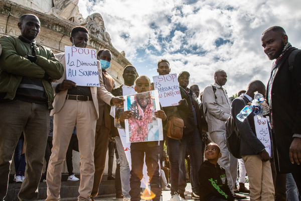 Men and children protesters hold a placard expressing their opinion concerning the situation in Sudan during a demonstration in the center of Paris. Around a hundred participants in Paris gathered together to call for a democratic political system in Sudan and denounced the violence against citizens in Sudan.
