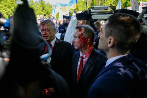 Sergey Andreev, the Ambassador of the Russian Federation, is being interviewed by journalists after he was covered with fake blood by Ukrainian activists. On the 77th anniversary of the Red Army victory over Nazi Germany Ukrainian activists performed at the Soviet soldiers cemetery in Warsaw as they protested against Russian invasion of Ukraine. Activists banned the Russian delegation headed by Sergey Andreev, the Ambassador of the Russian Federation in Poland, from entering the Cemetery. During that attempt diplomats were doused with fake blood by the Ukrainian activists.