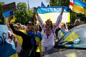 Women wrapped with Ukrainian flags shout slogans at the Russian delegation that tried to bring a funeral wreath to the Mausoleum of Soviet Soldiers in Warsaw. On the 77th anniversary of the Red Army victory over Nazi Germany Ukrainian activists performed at the Soviet soldiers cemetery in Warsaw as they protested against Russian invasion of Ukraine. Activists banned the Russian delegation headed by Sergey Andreev, the Ambassador of the Russian Federation in Poland, from entering the Cemetery. During that attempt diplomats were doused with fake blood by the Ukrainian activists.