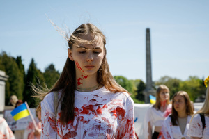 Woman covered with fake blood takes part during a protest at the Soviet soldiers cemetery in Warsaw on the Victory day. On the 77th anniversary of the Red Army victory over Nazi Germany Ukrainian activists performed at the Soviet soldiers cemetery in Warsaw as they protested against Russian invasion of Ukraine. Activists banned the Russian delegation headed by Sergey Andreev, the Ambassador of the Russian Federation in Poland, from entering the Cemetery. During that attempt diplomats were doused with fake blood by the Ukrainian activists.
