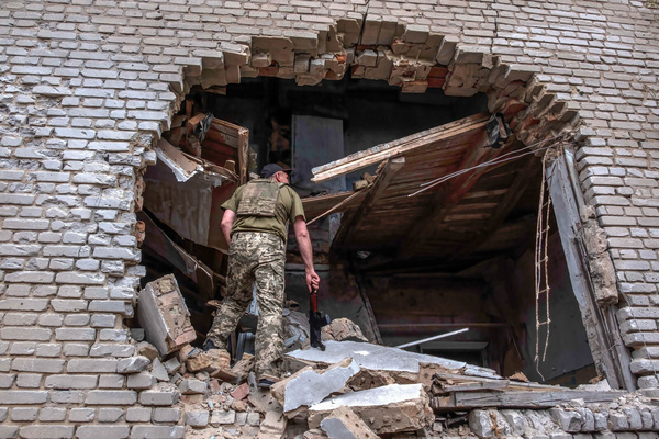 A soldier enters in the hole of building recently bombed, to inspect the damages. Malinovka is a village east of Zaporizhia city in Huliaipole district, Zaporizhia region, which was occupied by Russian army and retaken by Ukrainian army.