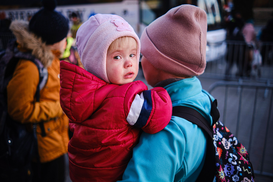 A child in his mother's arms looks sadly at the camera. The war in Ukraine has forced millions of Ukrainians to leave their country destroyed in a horrendous war. Carrying the bare minimum, women and children have crossed the border to settle in Poland and other European countries with the sole desire to return soon.
