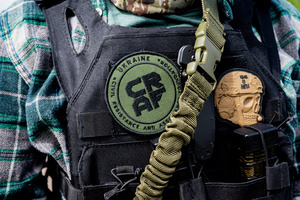 A patch saying "Civil resistance and assistance foundation" on a vest worn by a civilian volunteer training to enter the Ukrainian army. Russia invaded Ukraine on 24 February 2022, triggering the largest military attack in Europe since World War II. Over 3 million Ukrainians have already left the country and some are training for defense themselves.