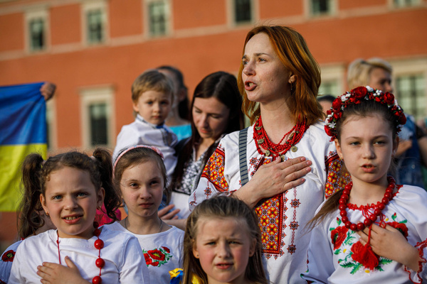 People wearing embroidered clothes sing the Ukrainian National Anthem during the Vyshyvanka Day celebration at Castle Square, Warsaw old town. Vyshyvanka Day is a Ukrainian holiday celebrated on the third Thursday of May annually since 2006. The aim of Vyshyvanka Day is to preserve traditional Ukrainian embroidered clothes called vyshyvanka and Ukrainian folk traditions. Vyshyvanka is one of the Ukrainian symbols.