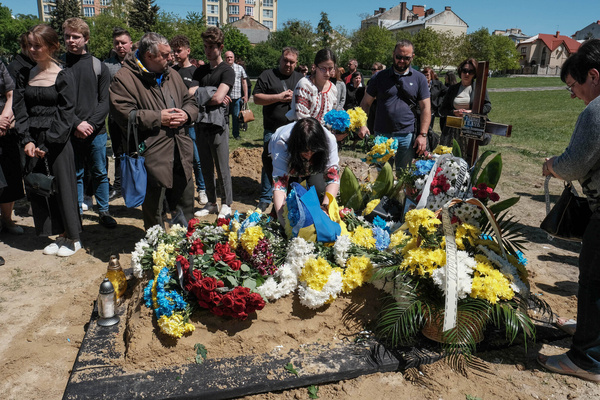 Women wearing traditional Ukrainian Vyshyvankas (embroidered shirts) seen at the grave of a Ukrainian soldier, Private Bogdan Volodymyrovych who was killed by Russian forces near Dryzba in Luhansk region at Lychakiv Cemetery.