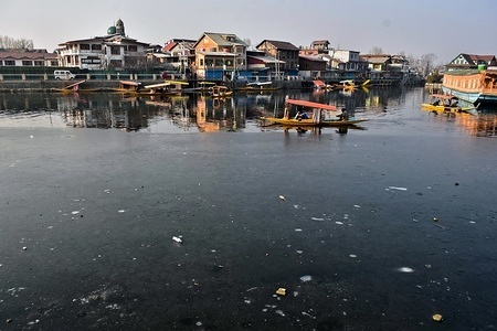 A boatman seen making his way through partially frozen water of Dal Lake on a cold winter day in Srinagar, Indian administered Kashmir.
The night temperatures in Kashmir rose by several degrees owing it to a cloudy sky, providing huge relief to the residents from the intense cold wave.
However, the temperatures continued to settle below the freezing point. Srinagar recorded a low of minus 2.4 degrees Celsius at night an increase of nearly five degrees from minus 7.2 degrees Celsius.