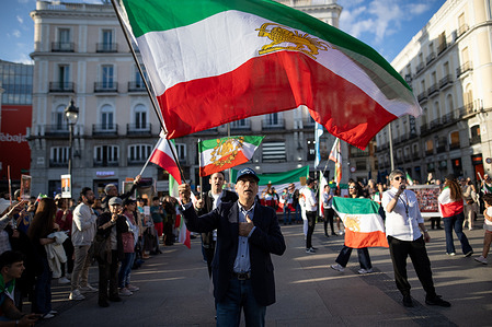 A protester marches with the Iranian flag during the celebration. During a gathering of Iranian residents in Madrid's Puerta del Sol to celebrate the US and Israeli bombings this morning in various cities across Iran and the potential fall of the ayatollahs' theocratic regime.
