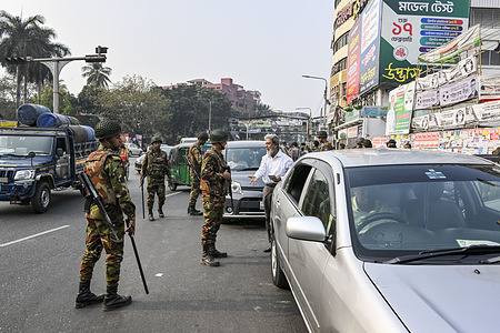 Bangladesh Army members conduct vehicle inspections at a checkpoint in the capital, one day ahead of the 13th Bangladesh National Parliament Election as part of heightened security measures across the country.