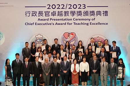 The government officials take photos with the award winners. The award presentation ceremony of Chief Executive's Award for Teaching Excellence was held by Hong Kong government at Central Government Offices. The purpose of the award is to praise the teachers who do excellent work. The Acting Chief Executive of Hong Kong, Mr Chan Kwok-ki and other government officials attend the ceremony.