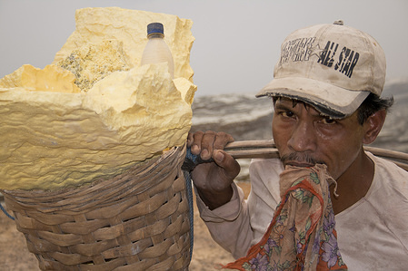 A miner carrying sulphur baskets.
In Java Island, Ijen Kawah volcano Crater Lake brings hundreds of miners in search of Sulphur every day, this Sulphur Lake is the biggest in the world, Sulphur is a precious material used in various. The mining job is considered as one of the toughest in the world. The strongest miners can carry 70 kg of Sulphur in baskets twice a day along a 7 km step way for 10 euros. They pay a high price in terms of health due to the toxic fumes, life expectancy is around 50 years.