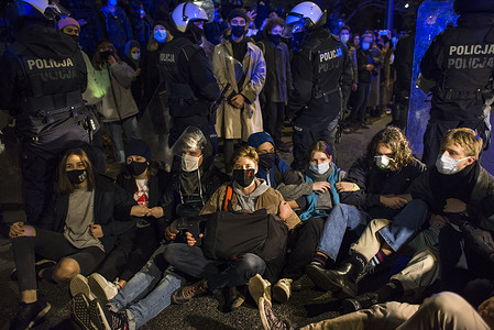 Protesters wearing face masks sit on the street while blocking the traffic during the demonstration.
The opponents of the ruling of the Constitutional Court on abortion protested once again.
Hundreds of people gathered outside the Ministry of National Education to demand the resignation of the minister of education and science, Przemyslaw Czarnek, known for his homophobic and chauvinistic public statements. On several occasions, the police forcefully dispersed protesters who had tried to block traffic and unexpectedly marched through the city centre. Numerous protesters were detained. The protest was organized by the Strajk Kobiet (Women's Strike) organization.