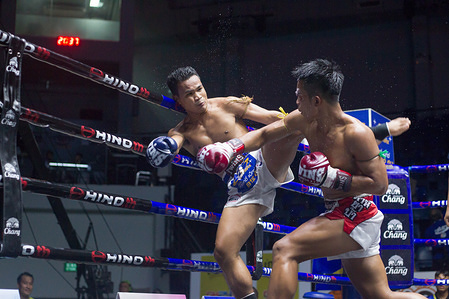 Boxers in action during the Thai Boxing match that was held without spectators as a preventive measure against the spread of COVID-19 coronavirus at Lumpinee Boxing Stadium.