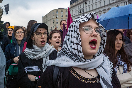 Protesters wearing the keffiyeh chant pro-Palestinian slogans during a demonstration in front of the Presidential Palace. On the evening of Friday, 30th May, a group of pro-Palestine activists and protesters gather at Poland's Presidential Palace in Warsaw. Carrying banners, placards, and flags, the protesters sought to remind the Presidential candidates of Sunday's Presidential election, and their voters, that accusations of genocide in Gaza are an urgent issue. UN Secretary General Antonio Guterres has stated that "the situation of the Palestinians in the Gaza Strip is beyond description, more than cruel and more than inhuman". At a time when approximately one hundred Palestinians have been killed every day in recent days, the protesters believe it crucial to ensure the issue is heard, particularly when Poland is still cooperating economically and militarily with the Israeli regime.