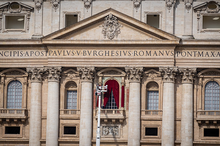 Workers install curtains on the main balcony of St Peter's Basilica in Vatican City, where the new Pope will be introduced to the world after the election.