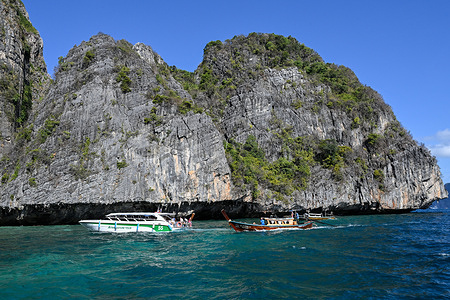 Tourists arrive by Speedboat and Long tail boats to visit Maya Bay beach on Phi Phi Leh Island in Krabi province.
