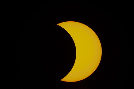 A comma shape of a sun seen as the moon almost covered the sun's disk (or sun disc) in the partial solar eclipse .