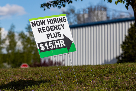 A now hiring sign is seen outside the window manufacturer Regency Plus.