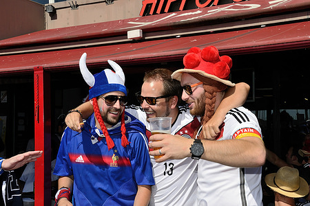 French and German supporters sing while drinking beer moments before the Euro 2016 match between the French and German.
