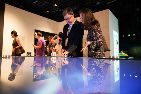 Visitors seen watching over a display at the exhibit. As part of a multi-year worldwide tour celebrating the Walt Disney Company's centenary, Disney: The Exhibition – A Century of Magic opens for a limited run at Chaoyang Joy City in Beijing from September 24, 2026, to March 31, 2027. Organized by the Walt Disney Archives, the international exhibition offers mainland Chinese audiences behind-the-scenes access to over 250 archival assets spanning Disney, Pixar, Marvel, and Star Wars films.