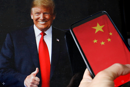 In this photo illustration, a portrait of a US president Donald Trump portrait with the Chinese national flag displayed on a mobile phone screen. US and China administration agreed to reduce tariffs for a period of 90 days.