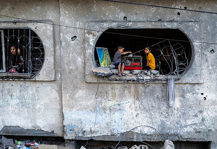 Kids play with a bird in a cage on the window of their destroyed house following the Israeli raids on the town of Beit Lahiya in the northern Gaza Strip during the recent fighting between Israel and Islamic Jihad. Israel carried out shelling attacks against the military leadership of the Palestinian Islamic Jihad Movement, in response to the firing of rockets towards Israel from the Gaza Strip. On May 13, 2023 a truce was agreed upon between Israel and the Palestinian Islamic Jihad movement after Egypt brokered negotiations between two parties.