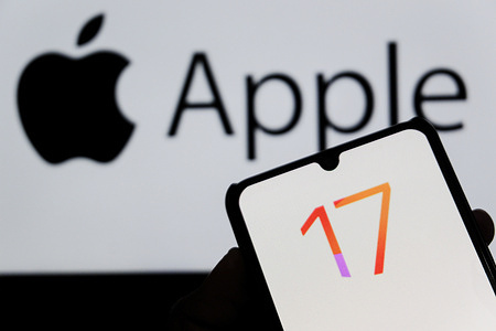 In this photo illustration, the IOS 17 Iphone logo displayed on a smartphone with an Apple logo in the background.