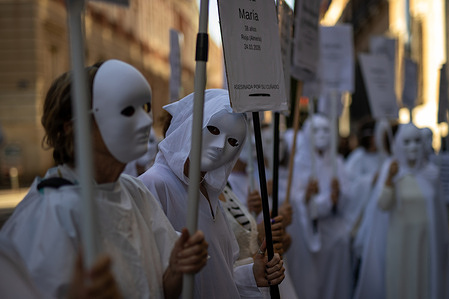 Women in white robes and masks hold placards during a demonstration against gender-based violence in front of the Ministry of Justice in Madrid. The feminist collective "Somos Ellas Madrid" (We Are Them Madrid), made up of anonymous women committed to raising awareness of femicides, held a demonstration in front of the Ministry of Justice. During the demonstration, the participants carried out a symbolic action: wearing white robes and masks and carrying signs with the names of women murdered so far in 2026, with the aim of making the victims visible and denouncing gender-based violence.