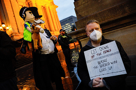 A protester holds a placard during the rally. A rally took place in Melbourne to oppose proposed legislation that would increase police authority to remove face coverings during the protests, impose restrictions on demonstrations near places of worship, limit civil disobedience activities, and mandate multicultural organizations to sign a “social cohesion” pledge to access funding. Attendees voiced concerns that these measures may curtail activism and civil rights.