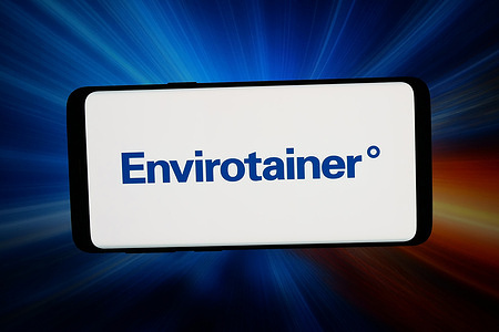 In this photo illustration, the logo of Swedish supply chain company Envirotainer is seen displayed on a smartphone in front of abstract background on computer screen.