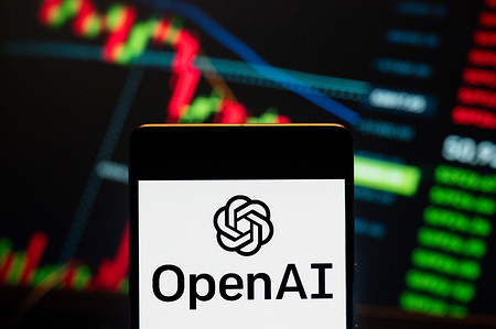 In this photo illustration, the American artificial intelligence (AI) organization consisting of the non-profit OpenAI logo seen displayed on a smartphone with a graph in the background.