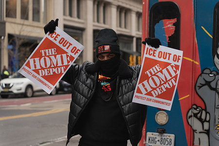 A demonstrator holds up placards outside of Home Depot’s 23rd Street location during the “ICE Out of Home Depot Save Our Communities” protest. Hundreds of protesters each purchased and then immediately returned low-cost items to pressure Home Depot to denounce and prevent U.S. Immigration and Customs Enforcement (ICE) raids at its stores and in parking lots. The movement used the slogan "Scrape ICE Out of Home Depot".