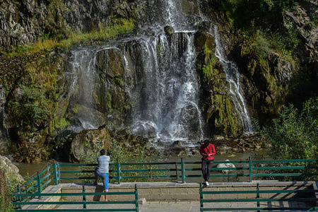 Visitors seen exploring the Drang waterfall on a sunny day in the summer capital of Jammu and Kashmir.